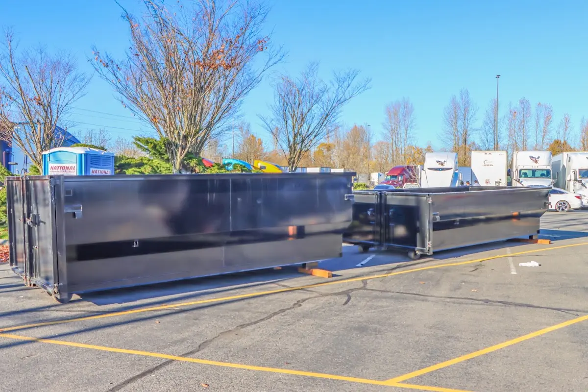 Professional dumpster rental service with roll-off container on residential driveway in Keene